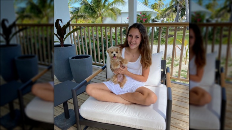 Charlotte Baeumler holding puppy, smiling