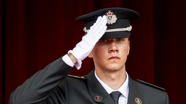 Prince Gabriel Of Belgium wears a military uniform and salutes.