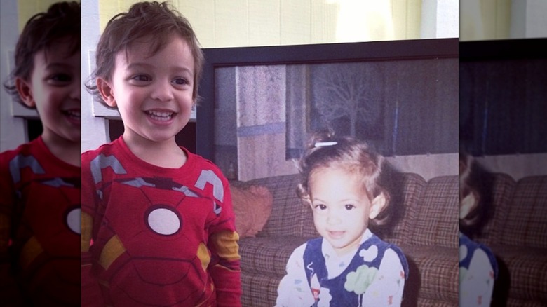 Michael grinning at a photo of Khalil at the same age