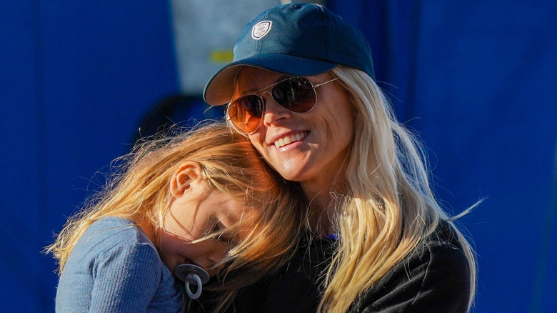 Elin Nordegren smiling and holding her daughter Zeta