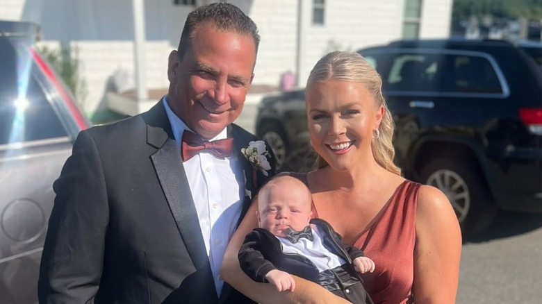 Karoline Leavitt posing with her husband and baby at a wedding