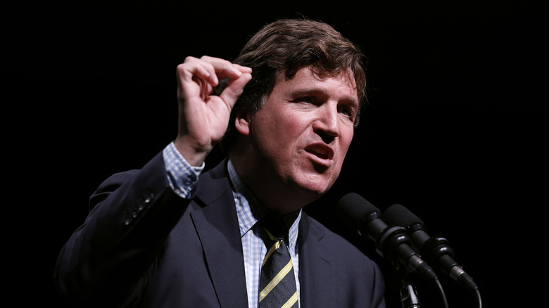 Tucker Carlson speaks at a podium