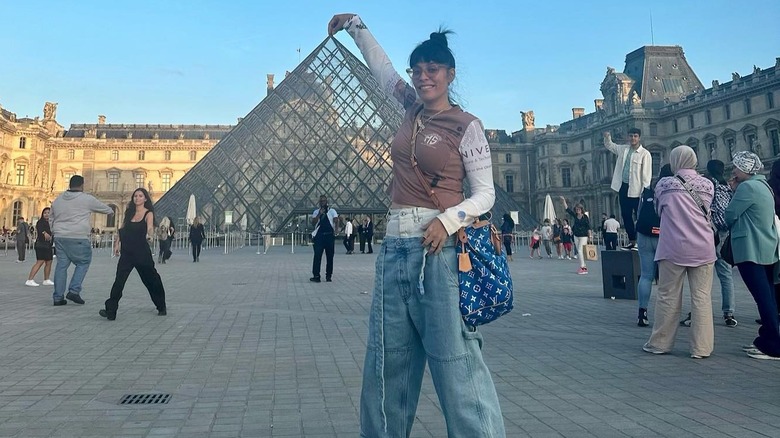 Jenn Goicoechea pinching the top of the Louvre