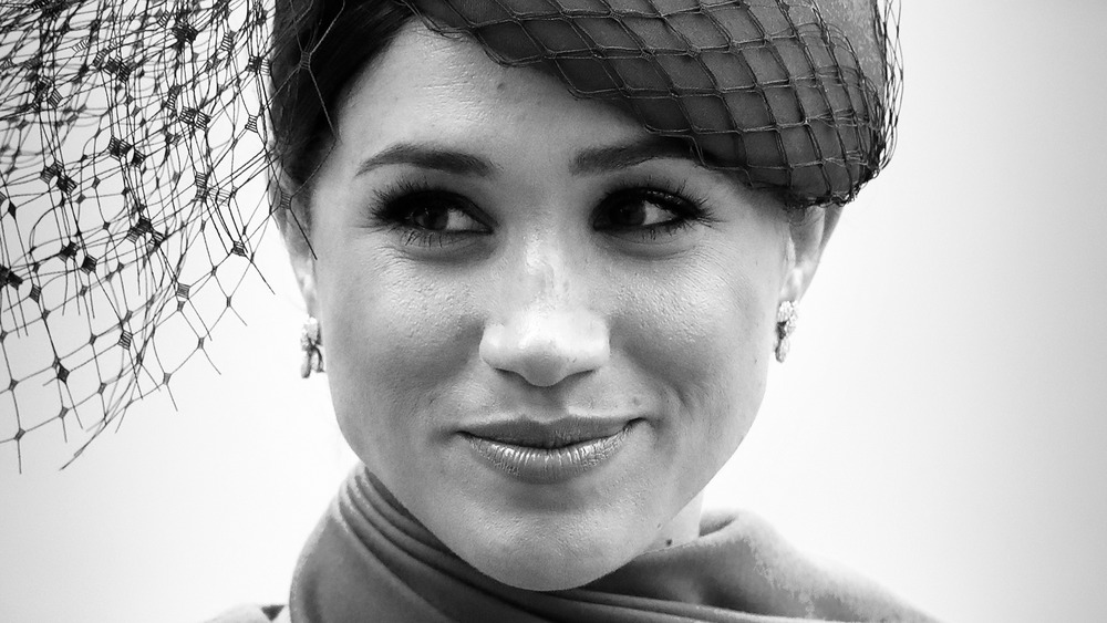 Meghan Markle grinning in hat