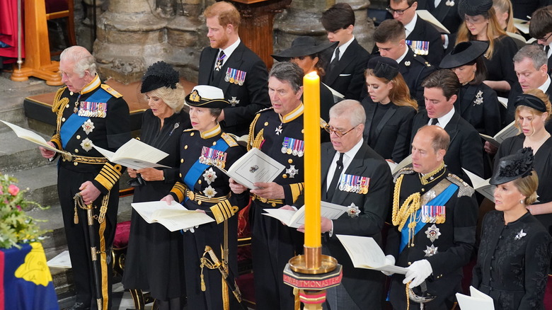 King Charles and royal family standing at Queen Elizabeth II's funeral