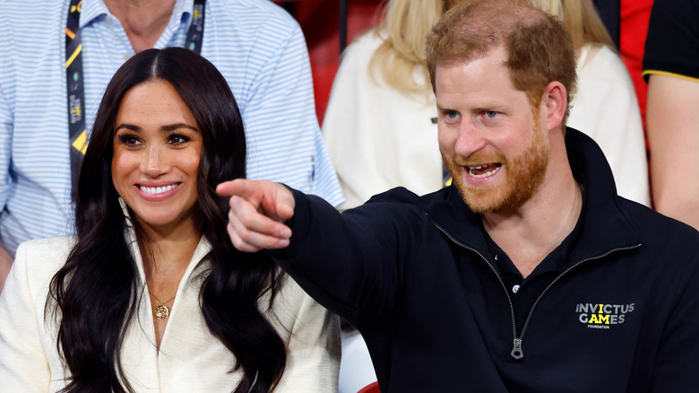 Prince Harry points something out to Meghan Markle