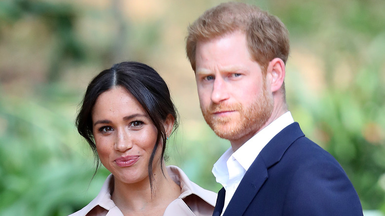 Meghan Markle and Prince Harry pose in a garden