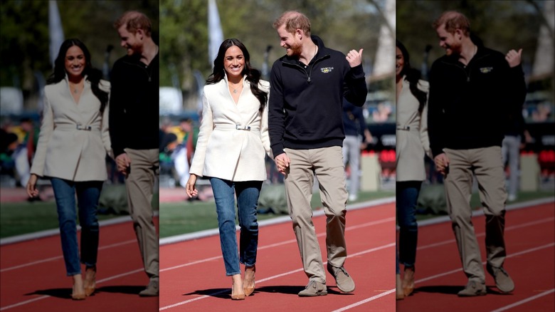 Meghan Markle and Prince Harry holding hands at the Invictus Games