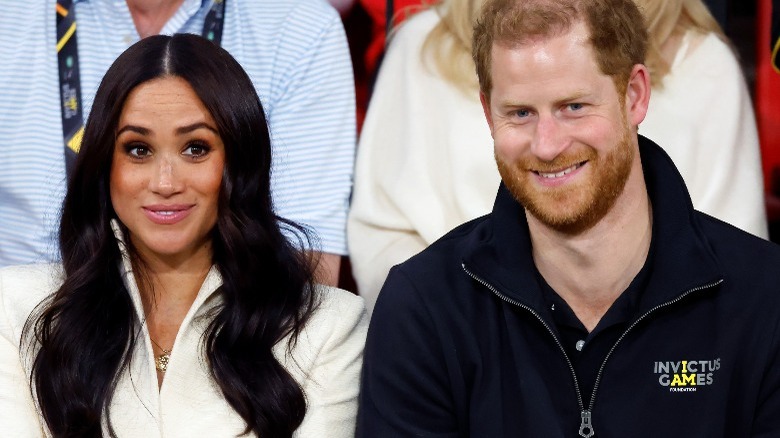 Meghan Markle and Prince Harry sit together