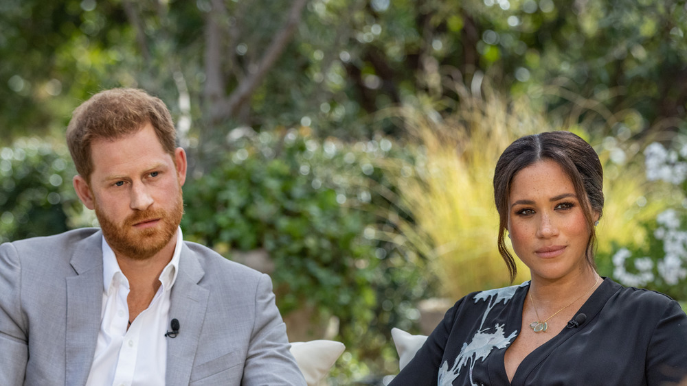 Harry and Meghan looking serious during Oprah interview