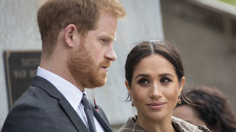 Meghan Markle listening to Prince Harry