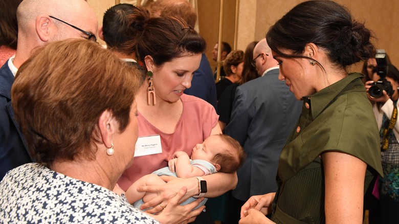 Meghan looking at a baby