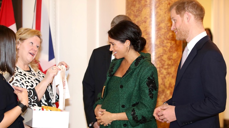 Meghan and Harry accepting present for baby