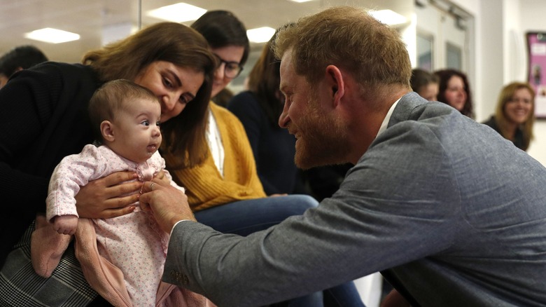 Prince Harry tickling a baby