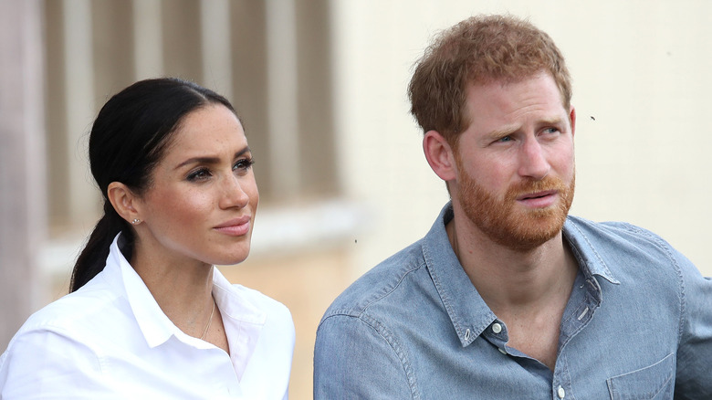 Prince Harry and Meghan Markle listen during an interview