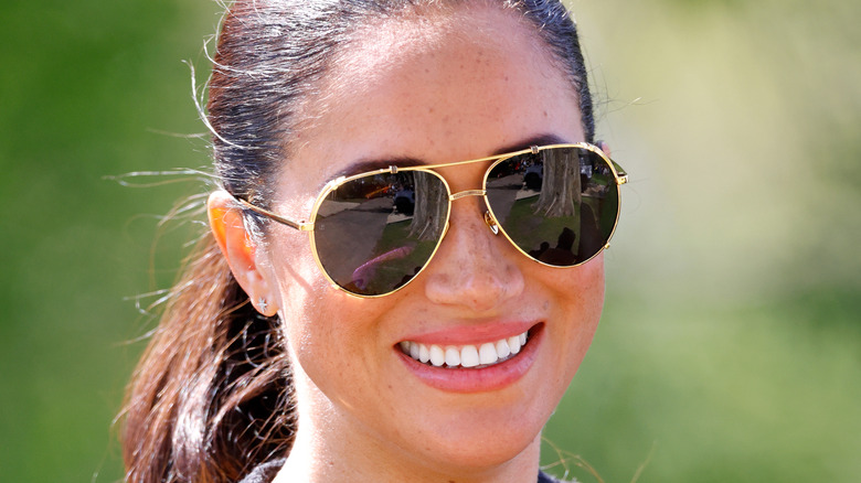 Meghan Markle smiling in sunglasses