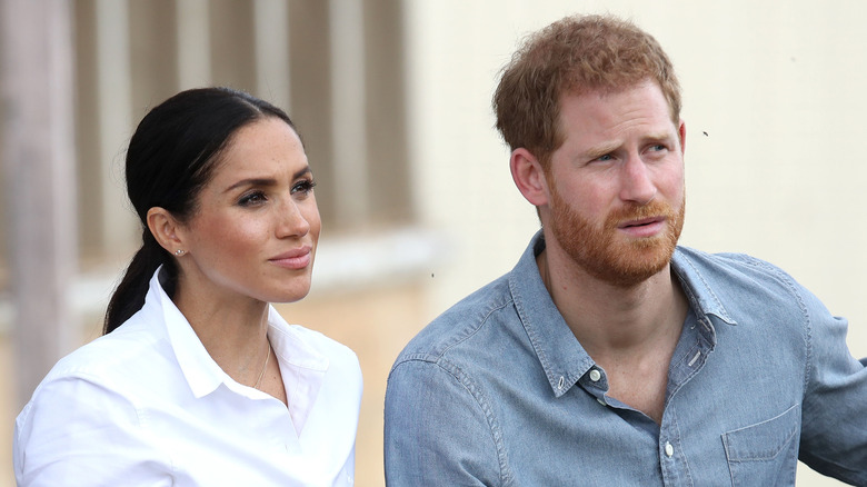 Meghan Markle and Prince Harry listening