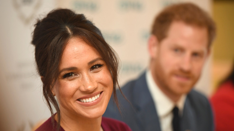 Meghan Markle smiling with Prince Harry