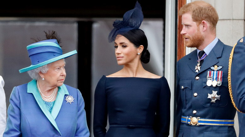 Queen Elizabeth looking sternly at Harry and Meghan