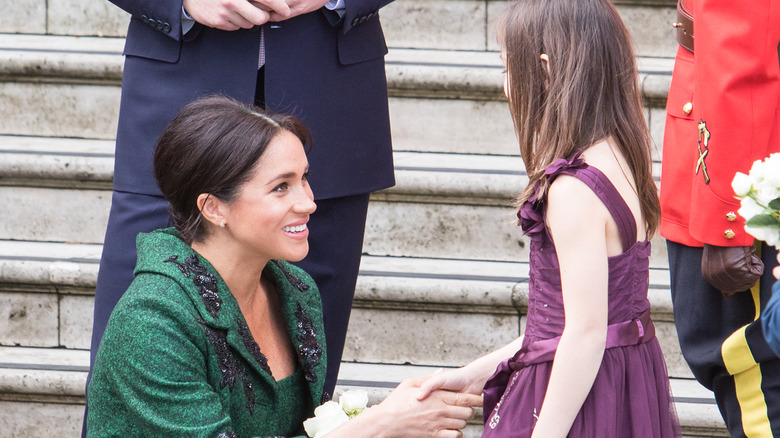 Meghan Markle interacting with little girl