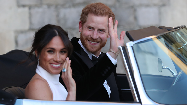 Meghan Markle and Prince Harry waving on their wedding day