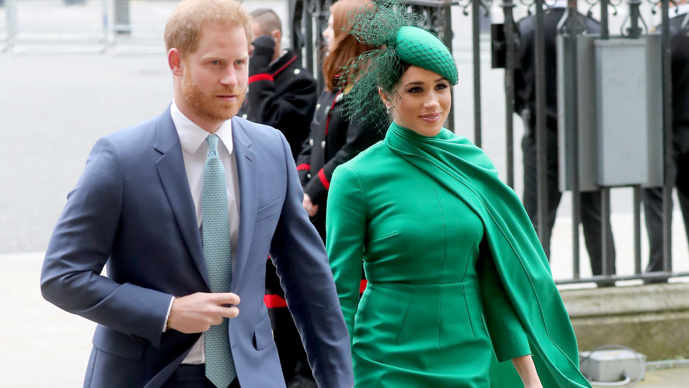 Meghan and Harry hold hands