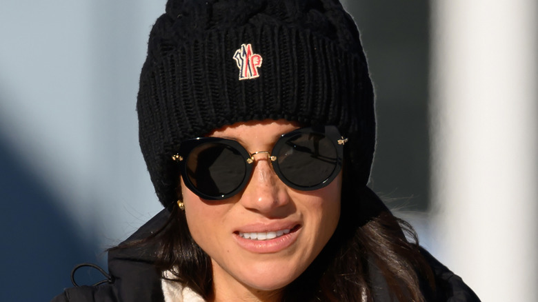 Meghan Markle looking confused in beanie hat and sunglasses