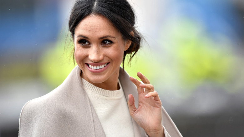 Meghan Markle waving coyly