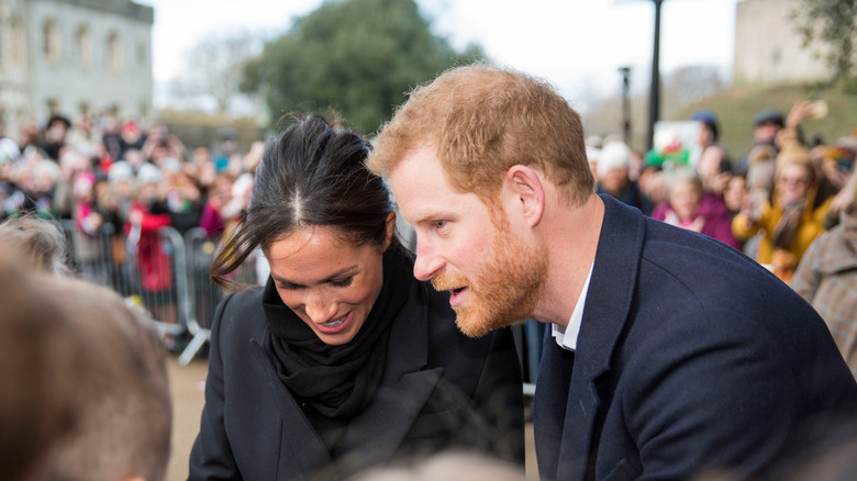 Meghan and Harry in 2018 greeting school children in Cardiff Castle