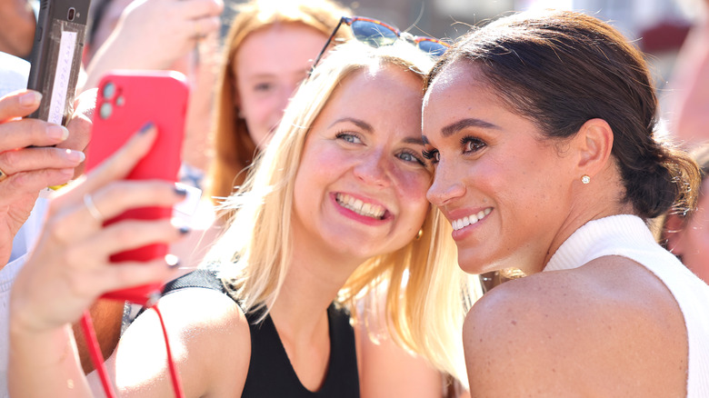 Meghan Markle taking selfie with fan