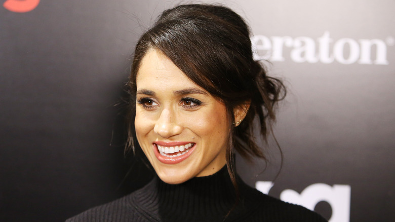 Meghan Markle smiling on red carpet