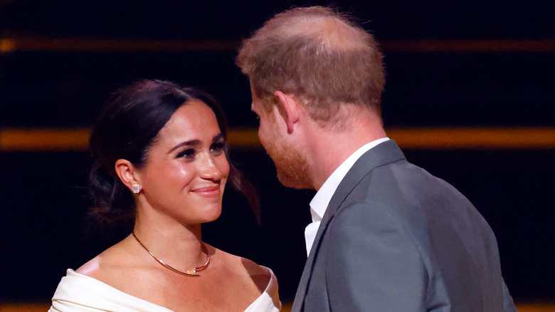 Meghan Markle smiles lovingly at Prince Harry