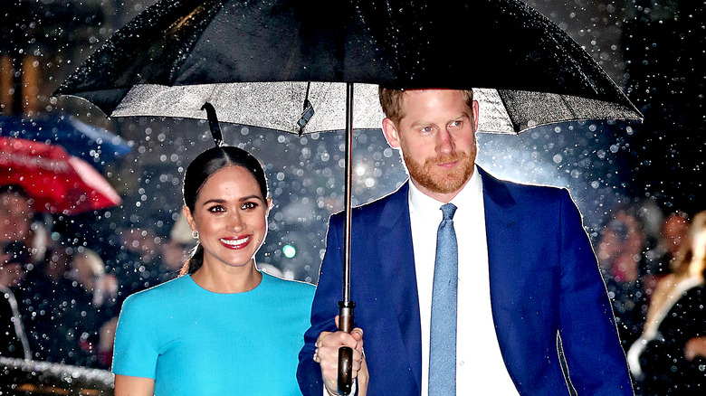 Meghan Markle and Prince Harry under an umbrella