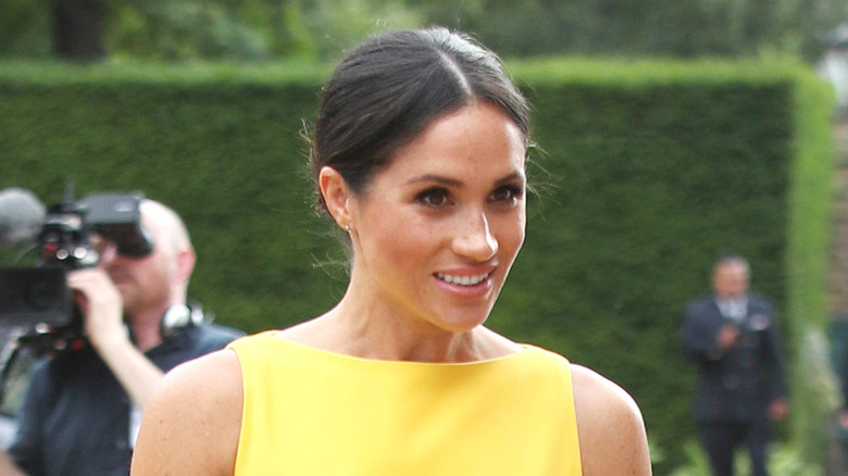 Meghan Markle walking in yellow