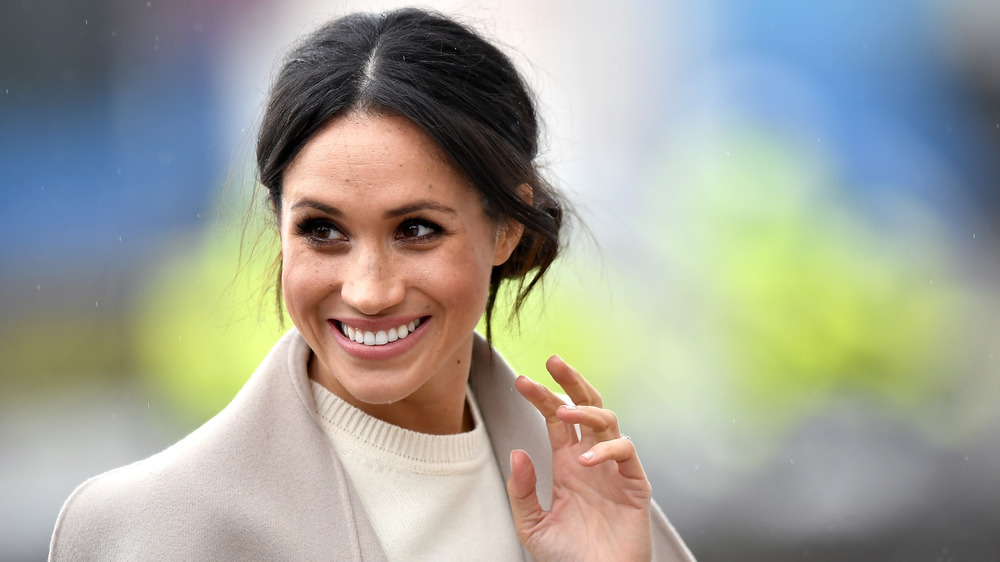 Meghan Markle waves to onlookers