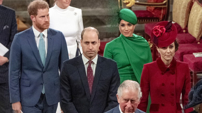 Kate Middleton, Prince William, Prince Harry, and Meghan Markle standing