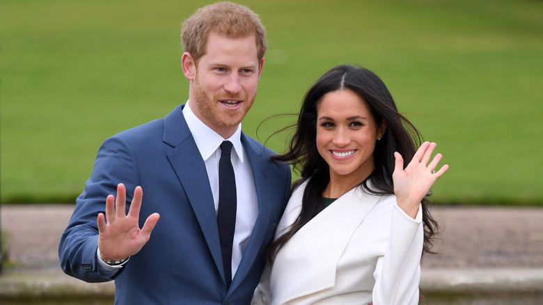 Prince Harry and Meghan Markle waving at Kensington Palace in 2017