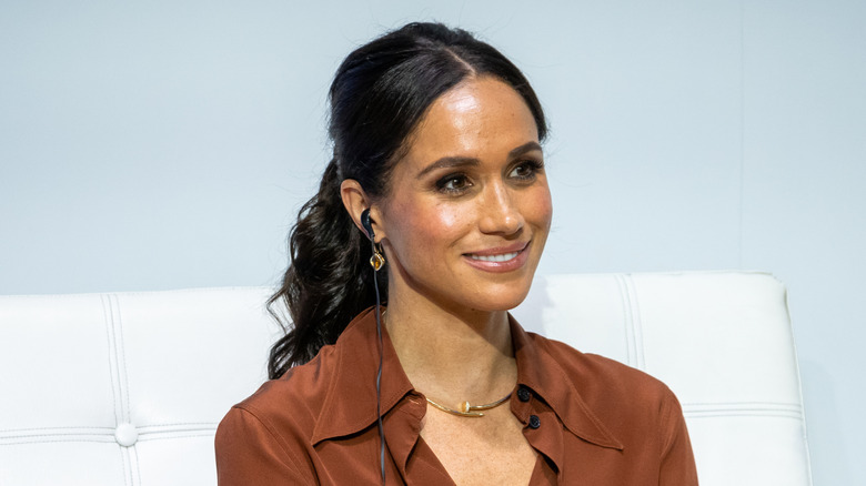 Meghan Markle smiling with low wavy ponytail