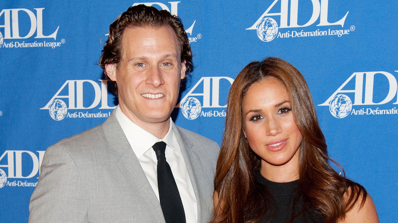 Meghan Markle and Trevor Engelson smiling on the red carpet