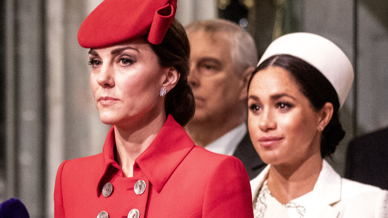 Meghan Markle stands behind Kate Middleton 