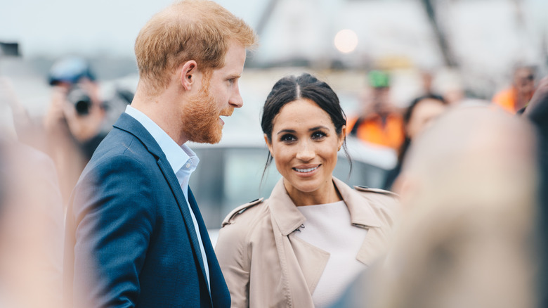 Prince Harry and Meghan Markle interacting with fans