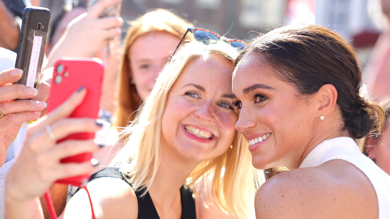 Meghan Markle taking a photo