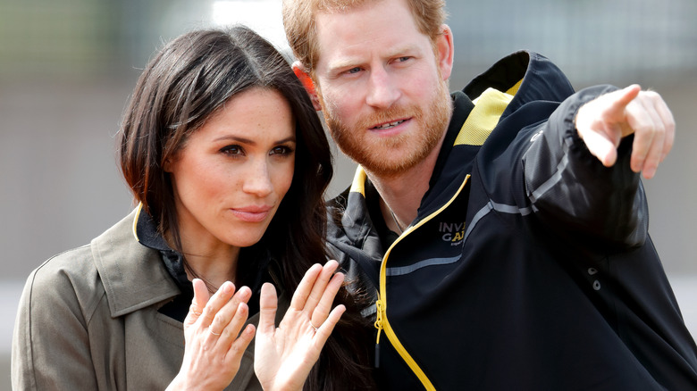 Prince Harry points something out to Meghan Markle