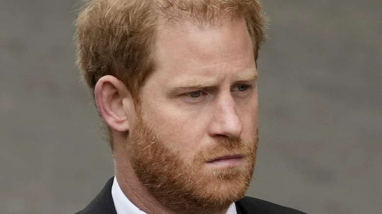 Prince Harry looking grumpy in a suit