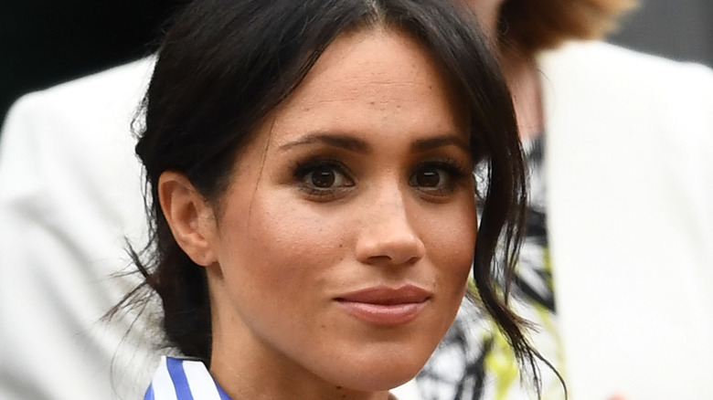 Meghan Markle looks thoughtful in the crowd at an event