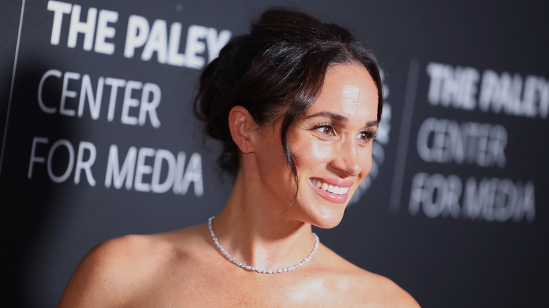 Meghan Markle smiling at a red carpet event