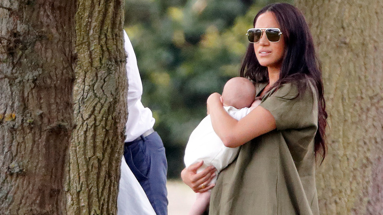 Meghan Markle holding baby Archie at polo match