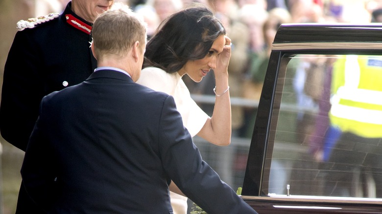 Meghan Markle entering car before Queen