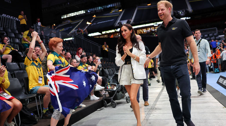 Meghan and Harry walking in arena