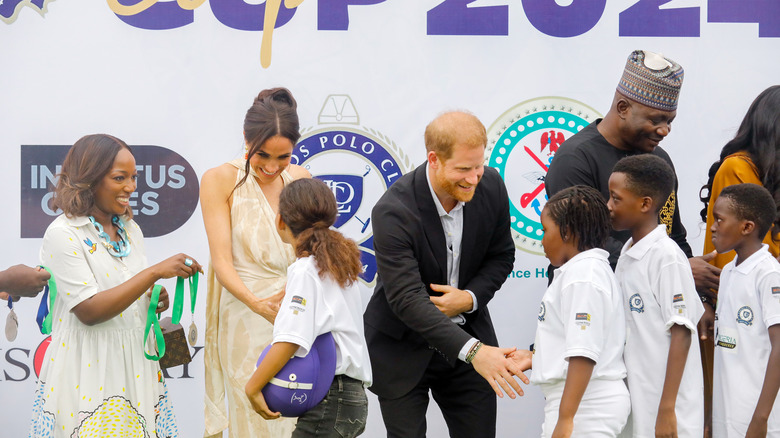 Meghan Markle and Prince Harry greeting guests 